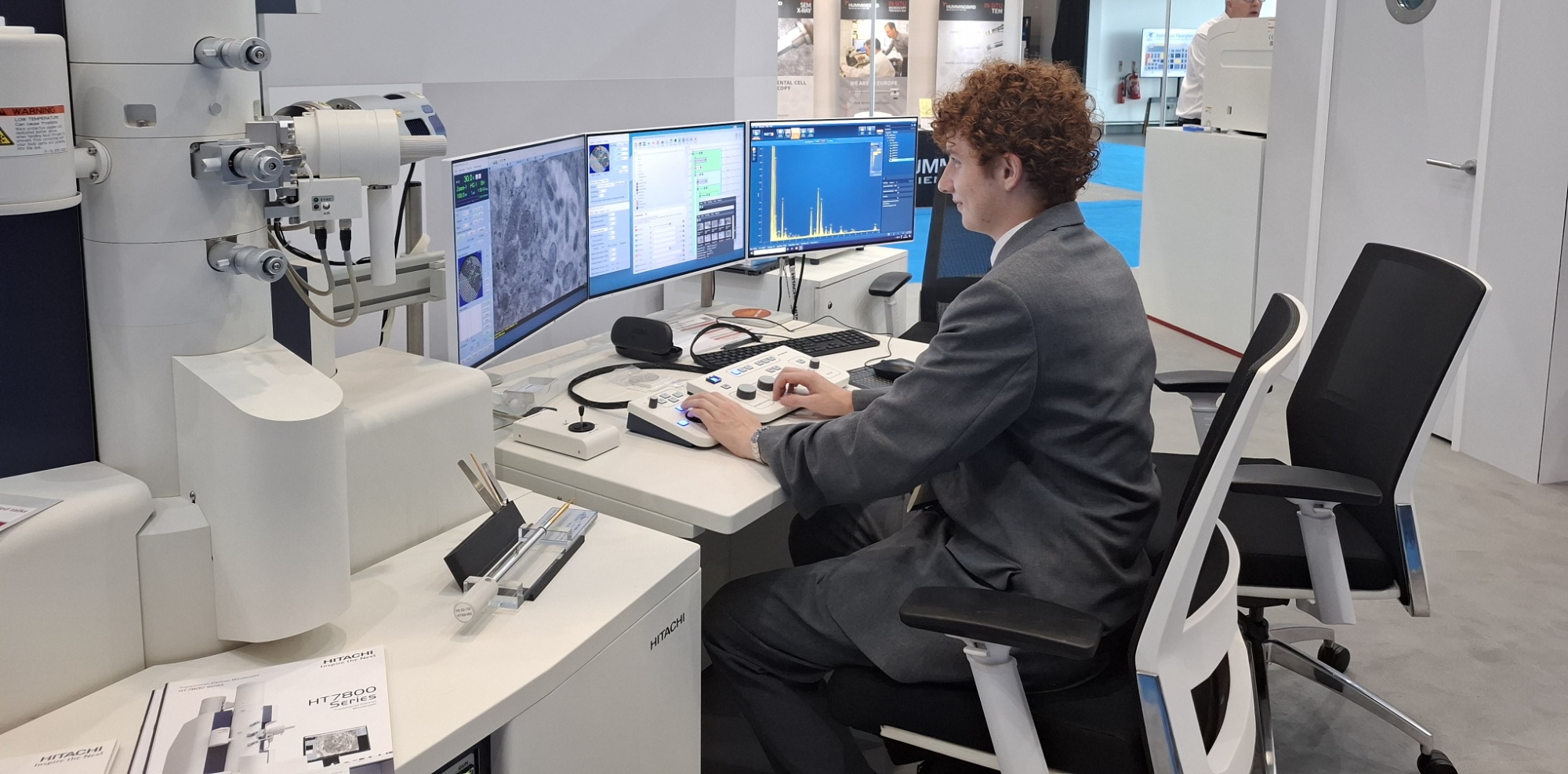 Image of sixth form student sat in front of a computer at the International Microscopy Congress